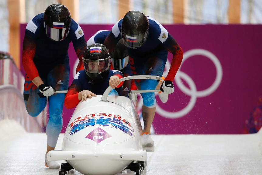 Russian crew start during a heat of the four-man bobsleigh event at the 2014 Sochi Olympics.