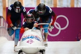 Russian crew start during a heat of the four-man bobsleigh event at the 2014 Sochi Olympics.