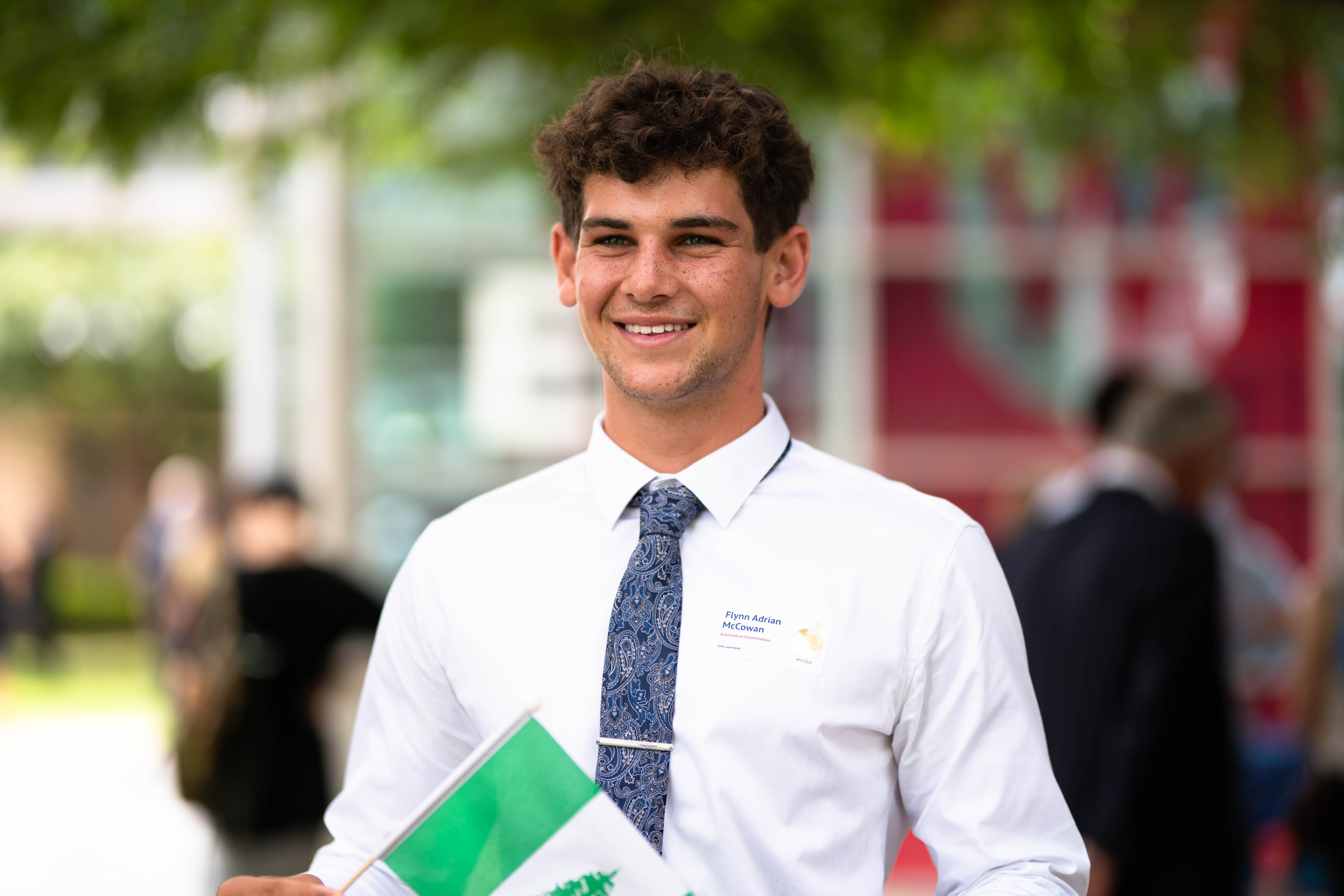 Man holding Norfolk island flag and wearing a white shirt