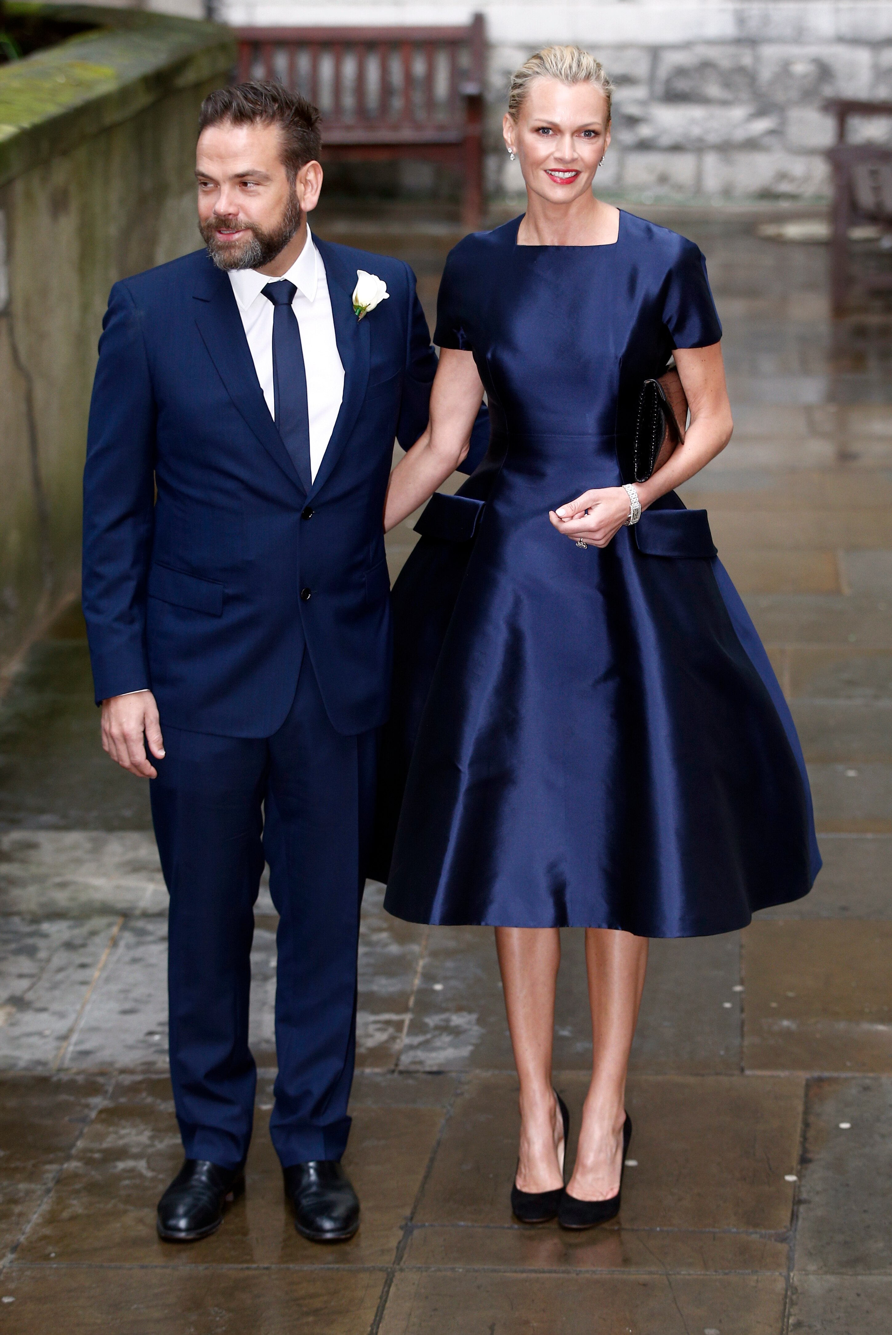 A man in a suit and a woman in a blue dress