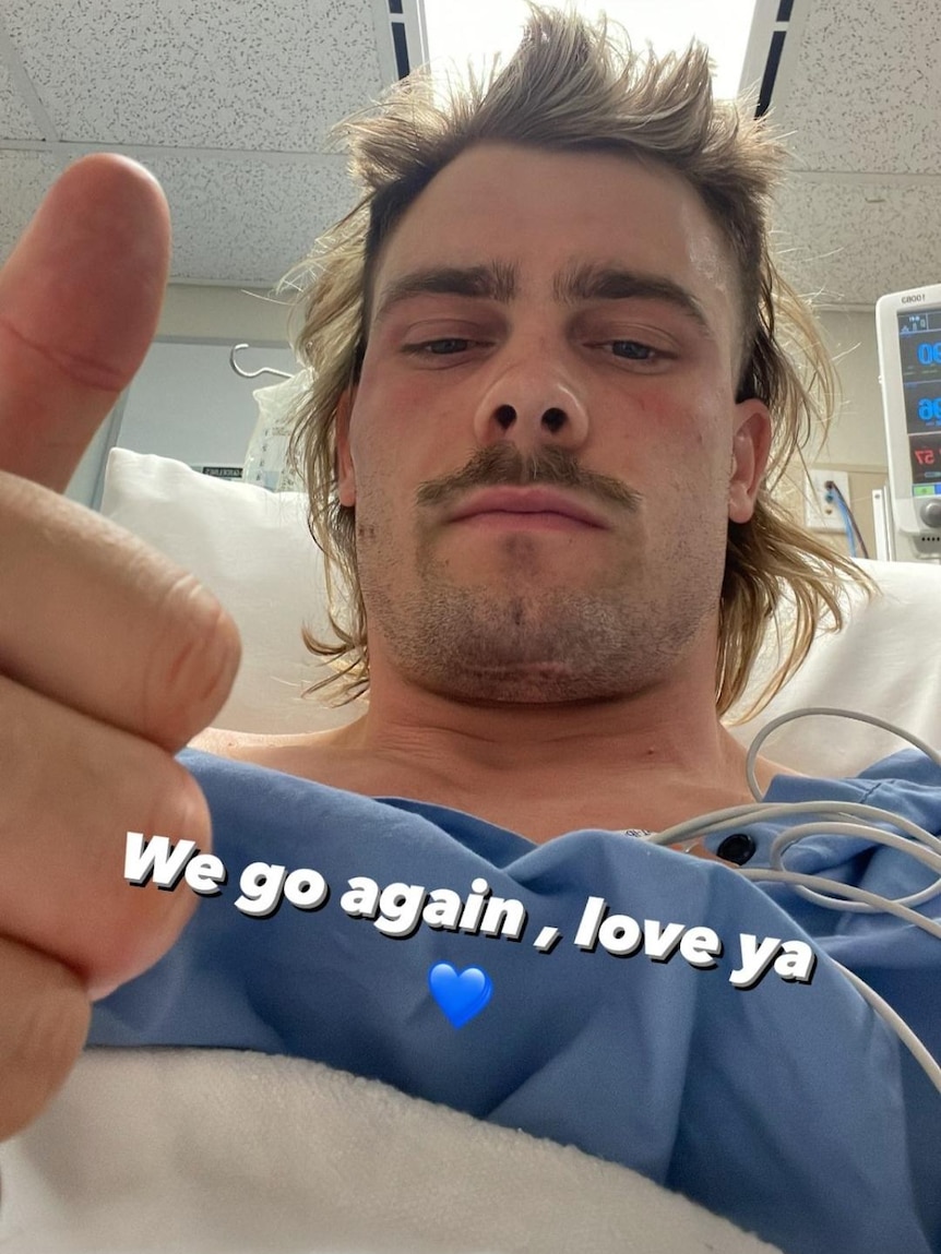 Ryan Papenhuyzen sits in a hospital bed, giving the thumbs up with the caption "We go again, love ya".