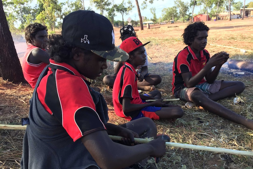 Boys make spears in Ramingining during NAIDOC week celebrations.