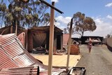 Trudy Ireland walks near her burnt house after a bushfire