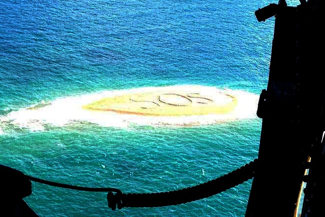 SOS message written in sand