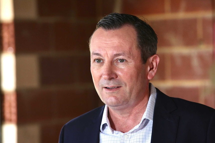 Mark McGowan looking pleased as he smiles before a media conference in a building site in Perth, WA.