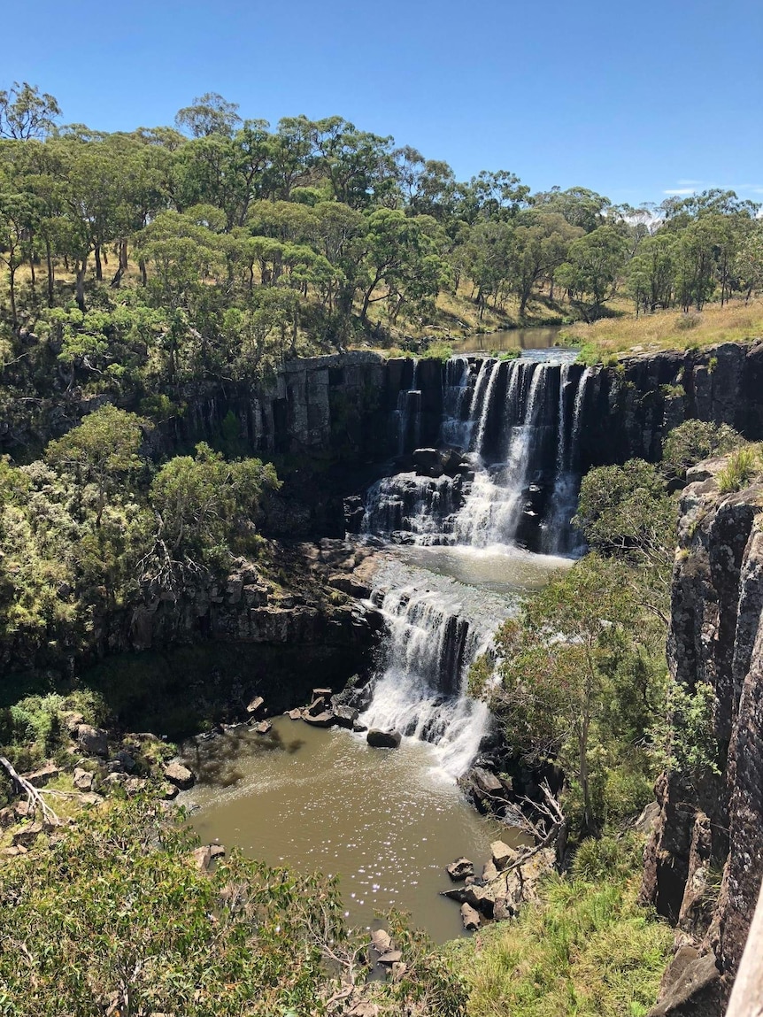 A waterfall flows in outback bush New South Wales.