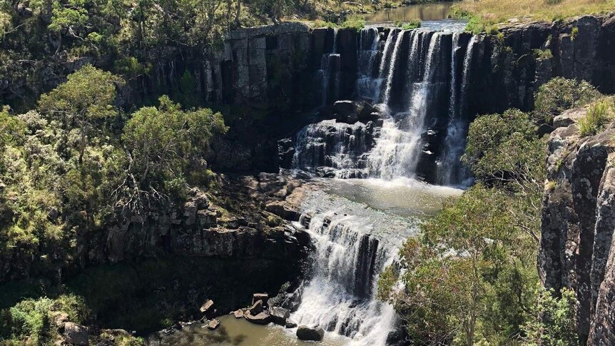 A waterfall flows in outback bush New South Wales.