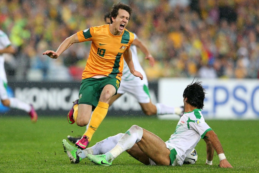 Ground challenge ... Robbie Kruse tries to escape a tackle