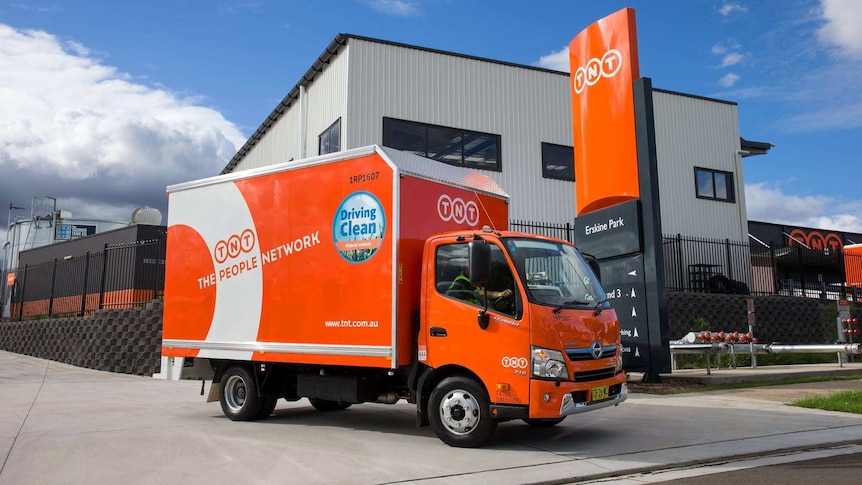 A TNT truck drives on a driveway in Erskine Park, NSW.