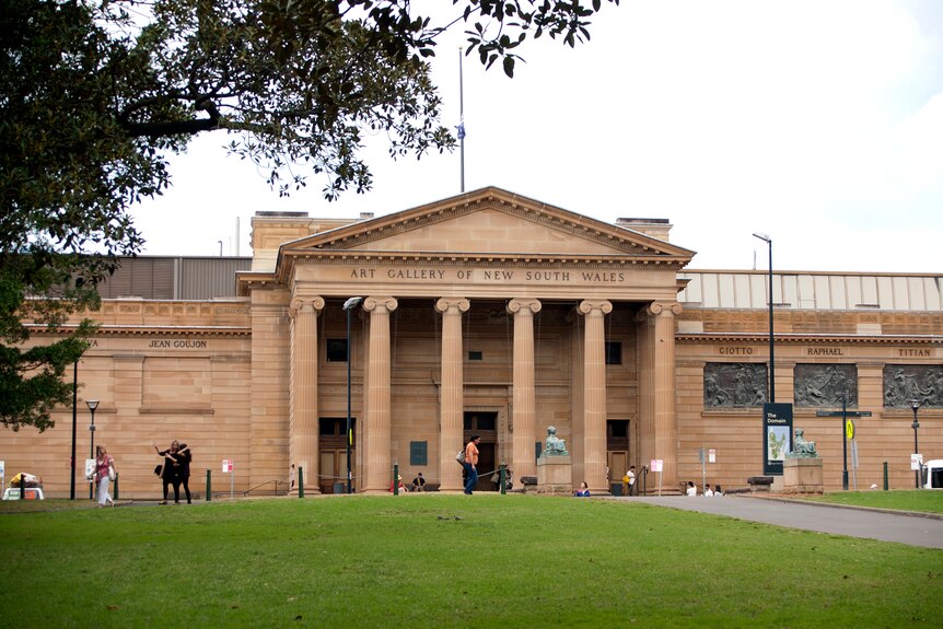 Photo of sandstone coloured building with large cylindrical pillars at the font, and 'Art Gallery of New South Wales' at top.