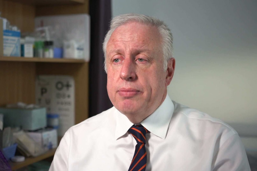 Dr Harry Nespolon, President of the Royal College of General Practitioners looks to the camera with a serious expression.