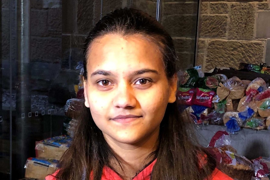 Snehapreet Kaur in front of groceries.