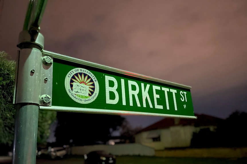 A picture of the green Birkett Street sign at dusk