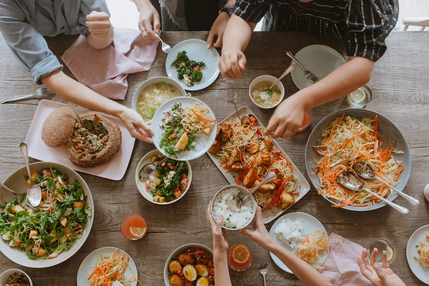 A vegetarian feast is shared by Hetty McKinnon's family featuring a rocket salad, soup, rice, ramen noodles and slaw.