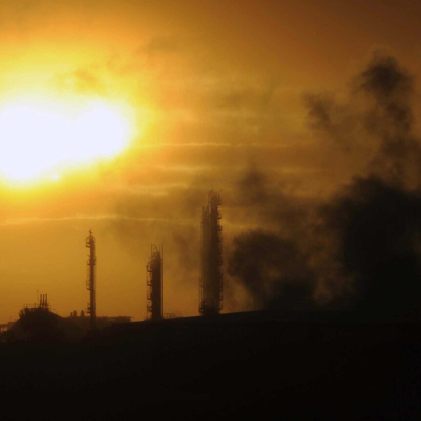 Emissions rise from an industrial plant in Melbourne - at sunset