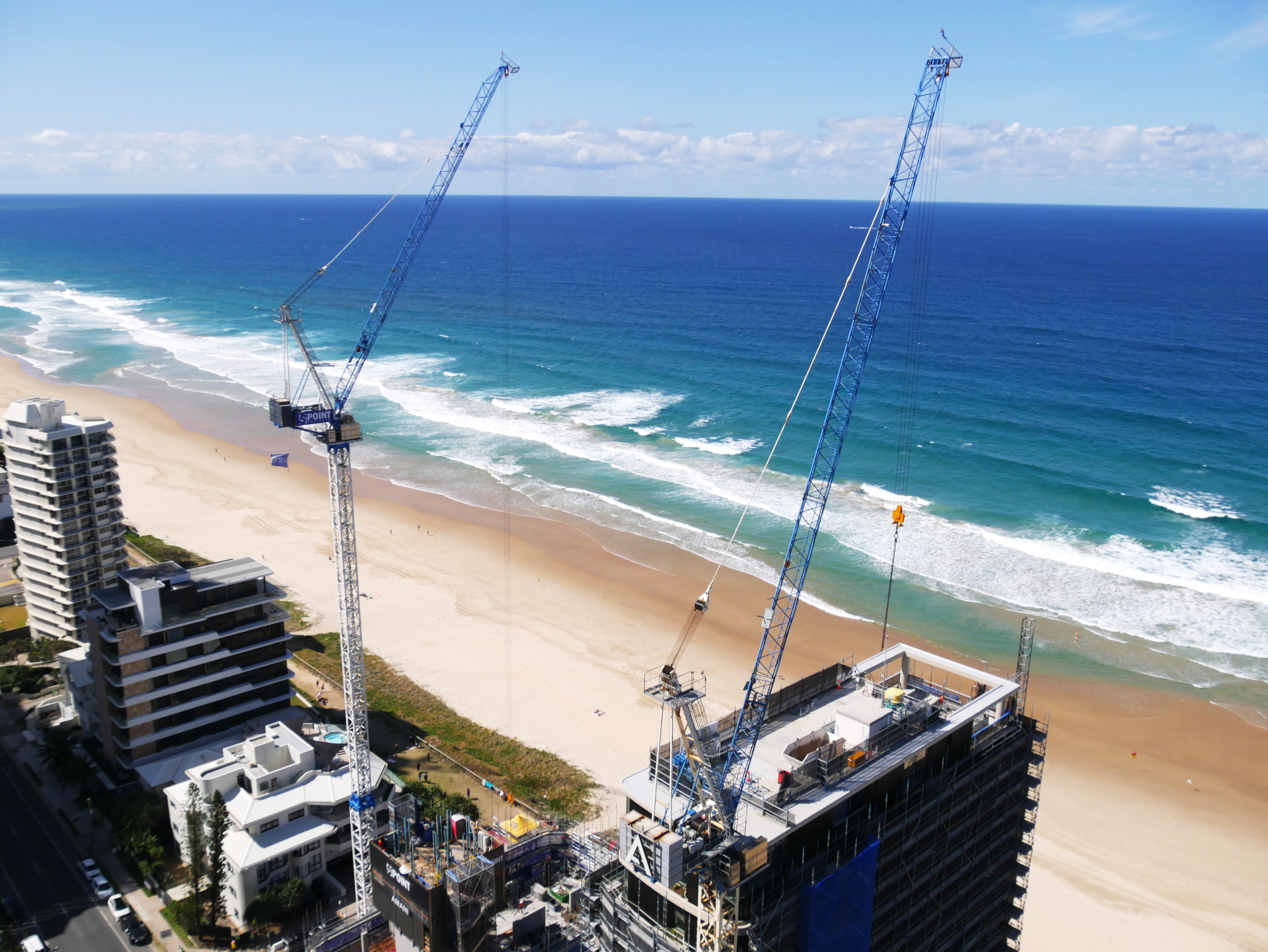 Two cranes over a building being constructed on the Gold Coast