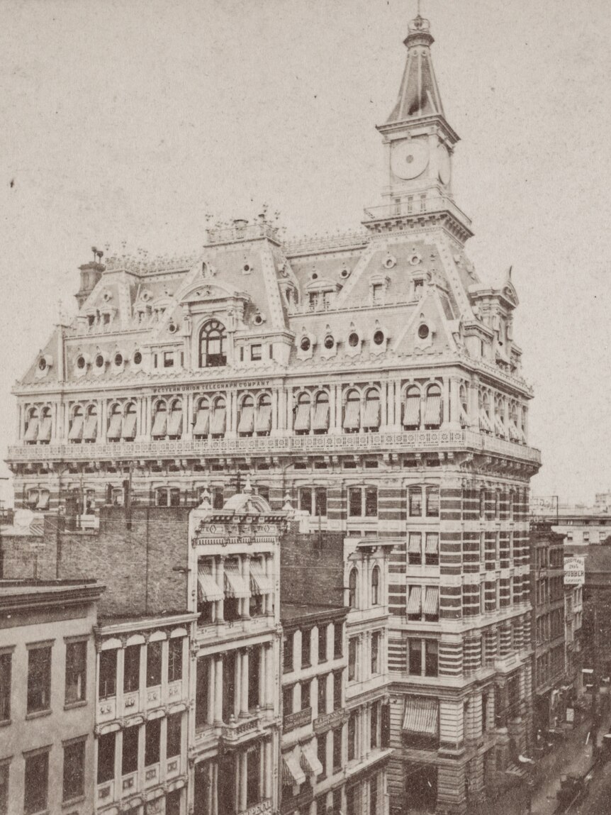 A sepia photo of a mid-1800s 10-floor building