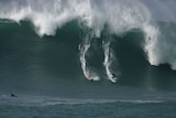 The Americans were surfing in massive waves of around 15 metres at Waimea Bay.