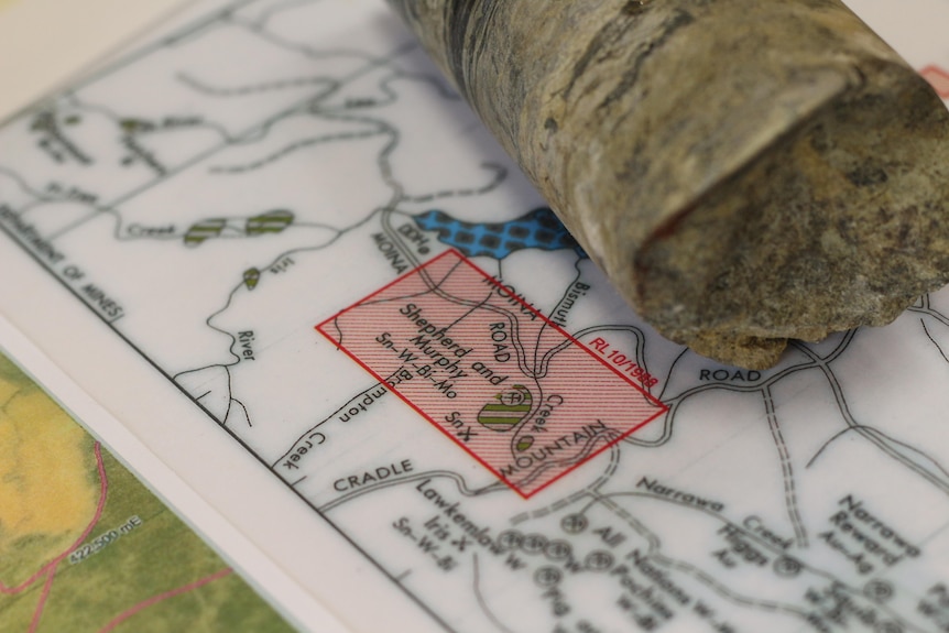 A close up of a map and a drilling rock sample.