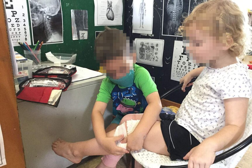 Children playing in an area labelled 'doctors surgery' at the Busy Kids Kindergarten and Child Care Centre in Townsville.
