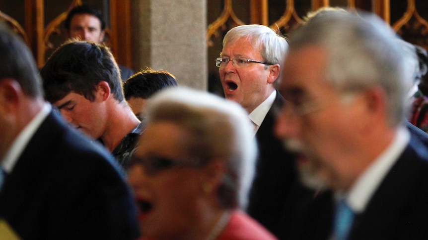 Kevin Rudd sings during church service.