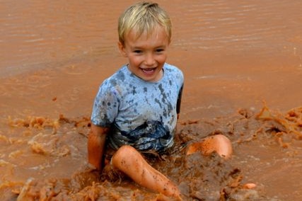 Charlie Kidd enjoying a puddle after 62 millimetres at his home Ourdel station, near Windorah.