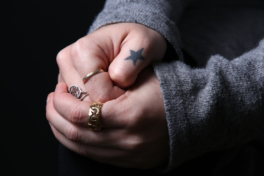 Anna Chaplin's hands clasped together.