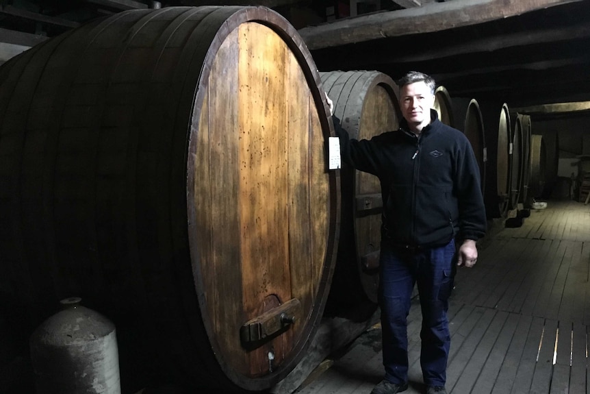 Justin Purser, winemaker at Best's Wines, with old wine barrels