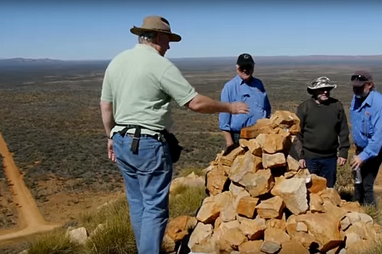 Ken Duncan (left) and others at the Haasts Bluff site of the proposed 20-metre tall illuminated cross.