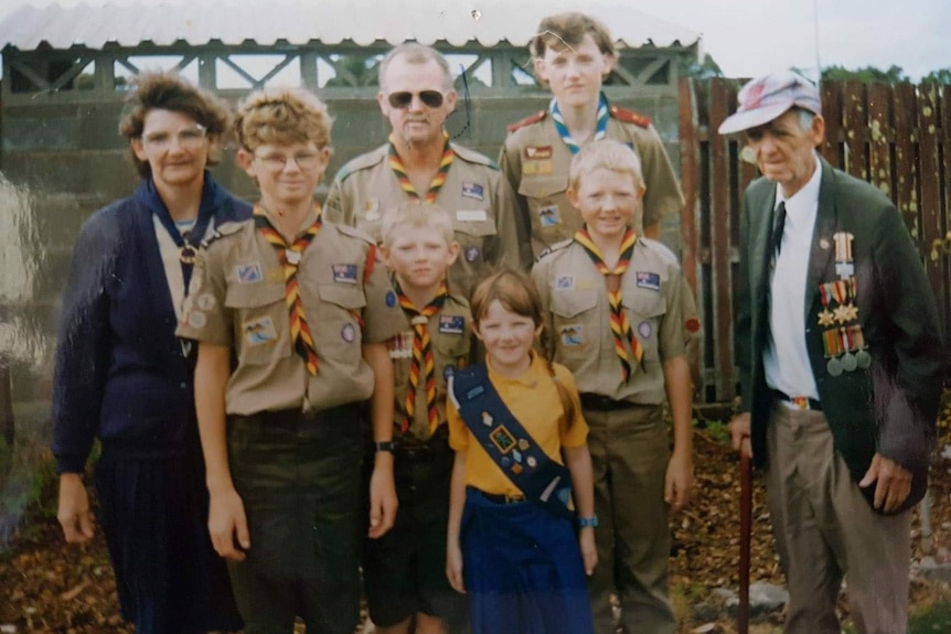 Three generations of a family, adults and children, all in Scouts uniforms