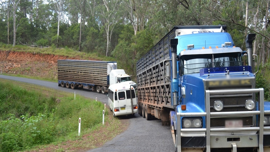 Trucks and a bus negotiating a bend on the Mount Lindesay Road north of Tenterfield