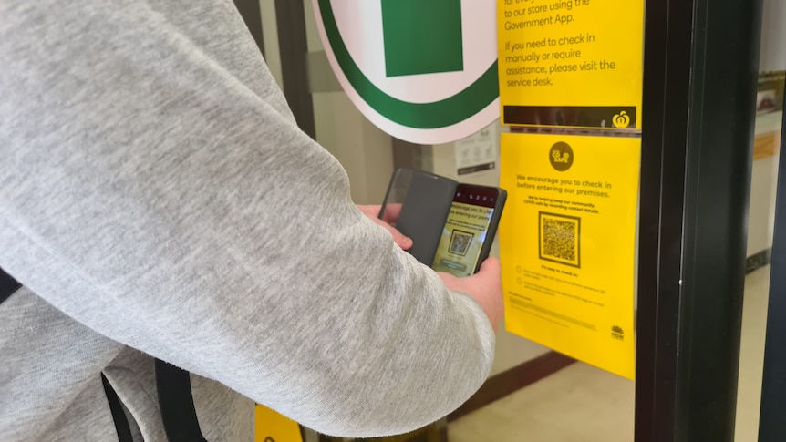 A man scans the QR code at a supermarket