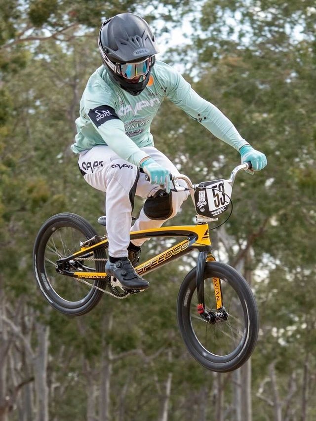 A bike rider makes a jump into the air