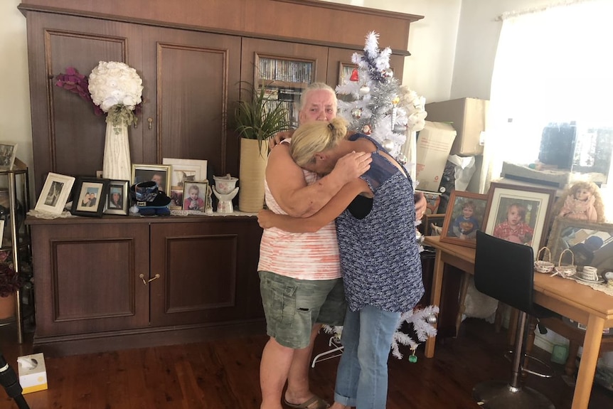 Sharon Spedding is comforted by her mother after losing her home in the Mount Maria fire.