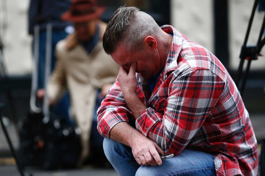 Paul Watt, a regular at The Clutha pub, mourns near the accident site.