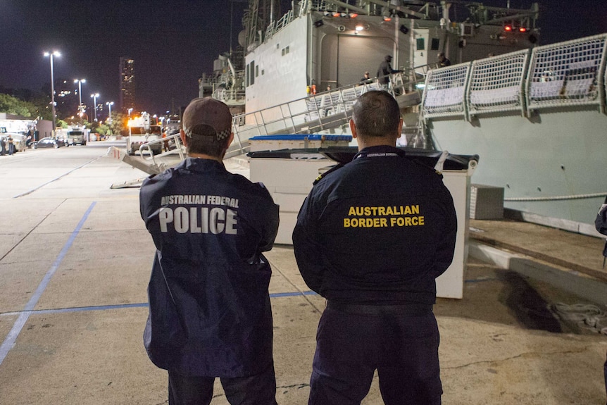 An Australian Federal Police officer and an Australian Border Force officer.