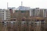A view of Chernobyl nuclear power plant in the background, from the abandoned town of Pripyat.