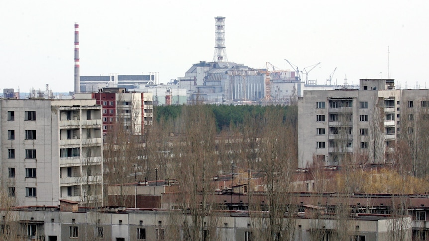 A view of Chernobyl nuclear power plant in the background, from the abandoned town of Pripyat.