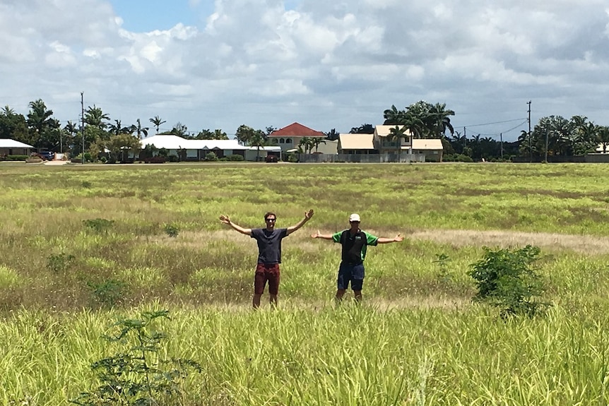Artist Lucas Ihlein and cane grower Simon Mattsson stand where their art project will take place.