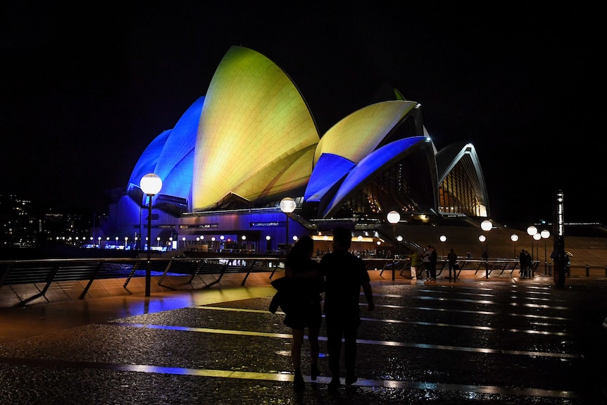Opera House sails lit up in the colours of the Ukrainian national flag.