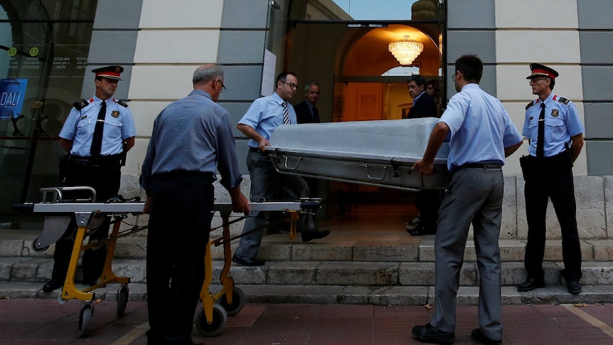 Workers carry a coffin to be used during the exhumation of Spanish artist Salvador Dali