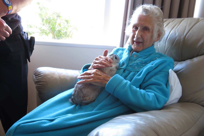 Nursing home resident holds a rabbit