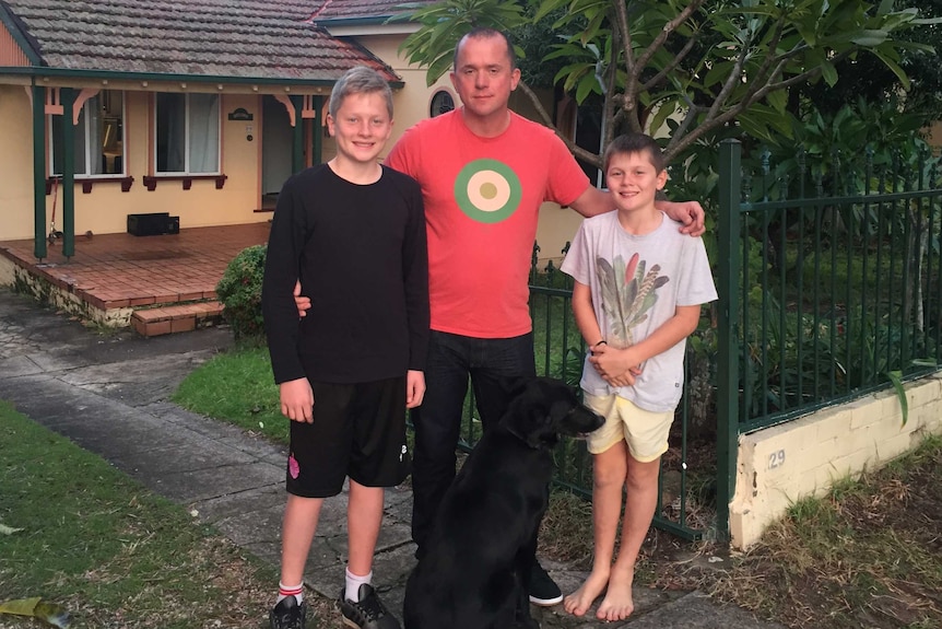 Paul Handley and his sons outside their home