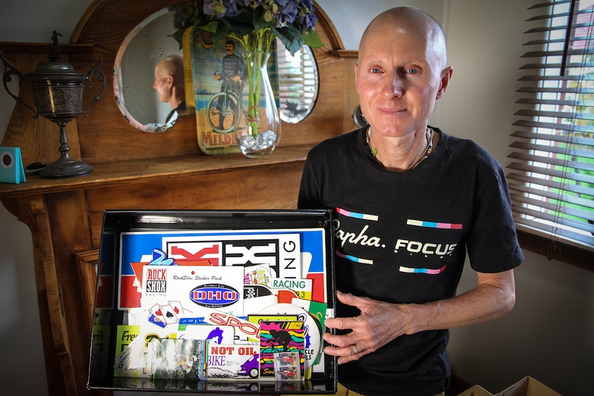 Danny Hennessy displays a box of vintage stickers.