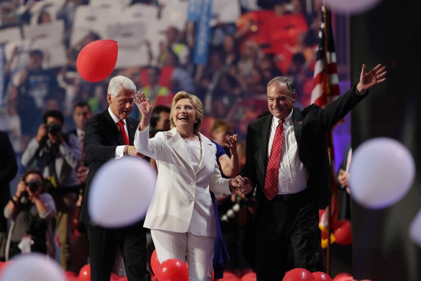 Hillary Clinton walks through falling balloons with running mate Tim Kaine