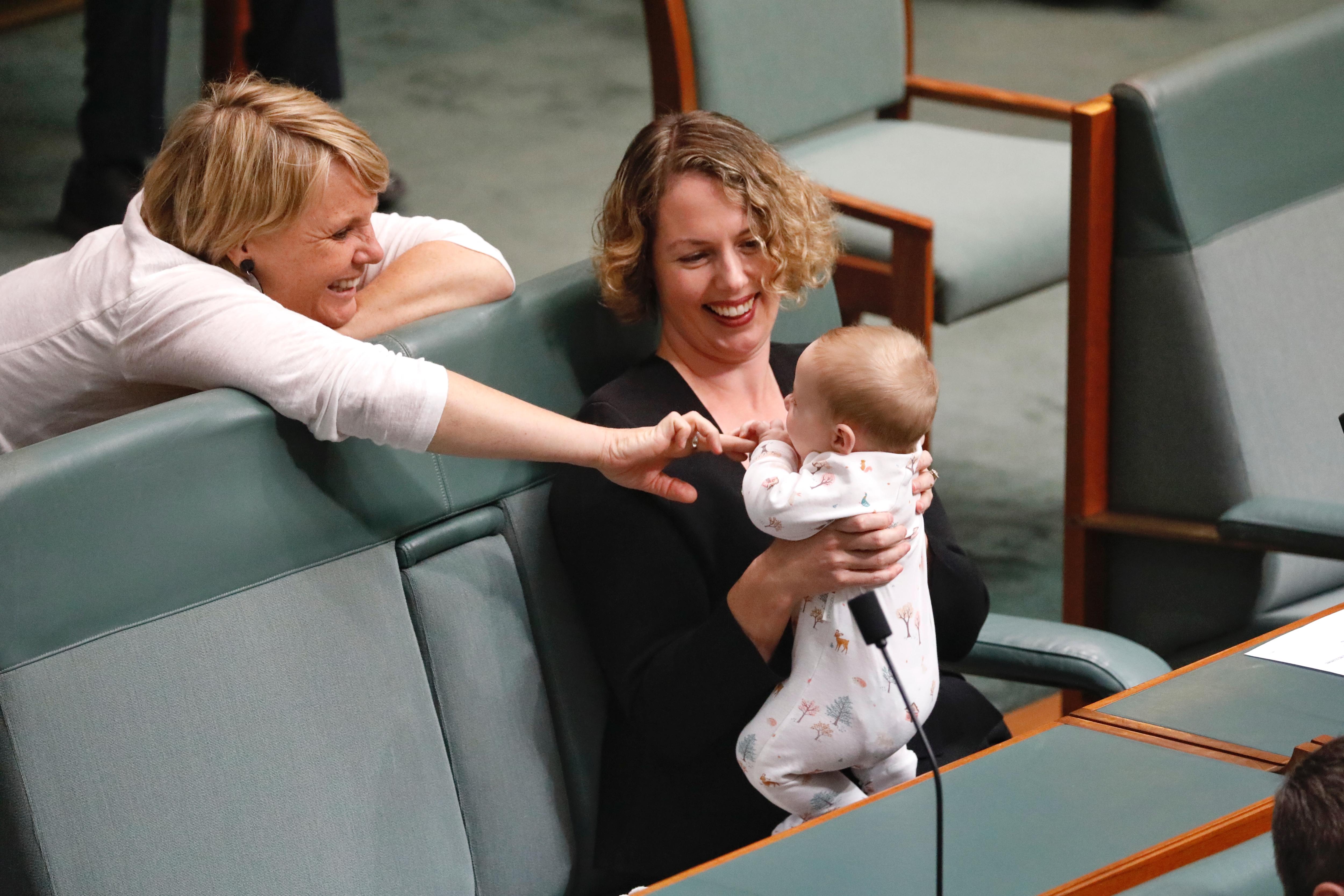 Peta Murphy playing with Alicia Paynes baby. 