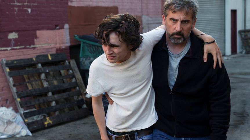 Colour photol of Timothée Chalamet and Steve Carell in alleyway in 2018 film Beautiful Boy.