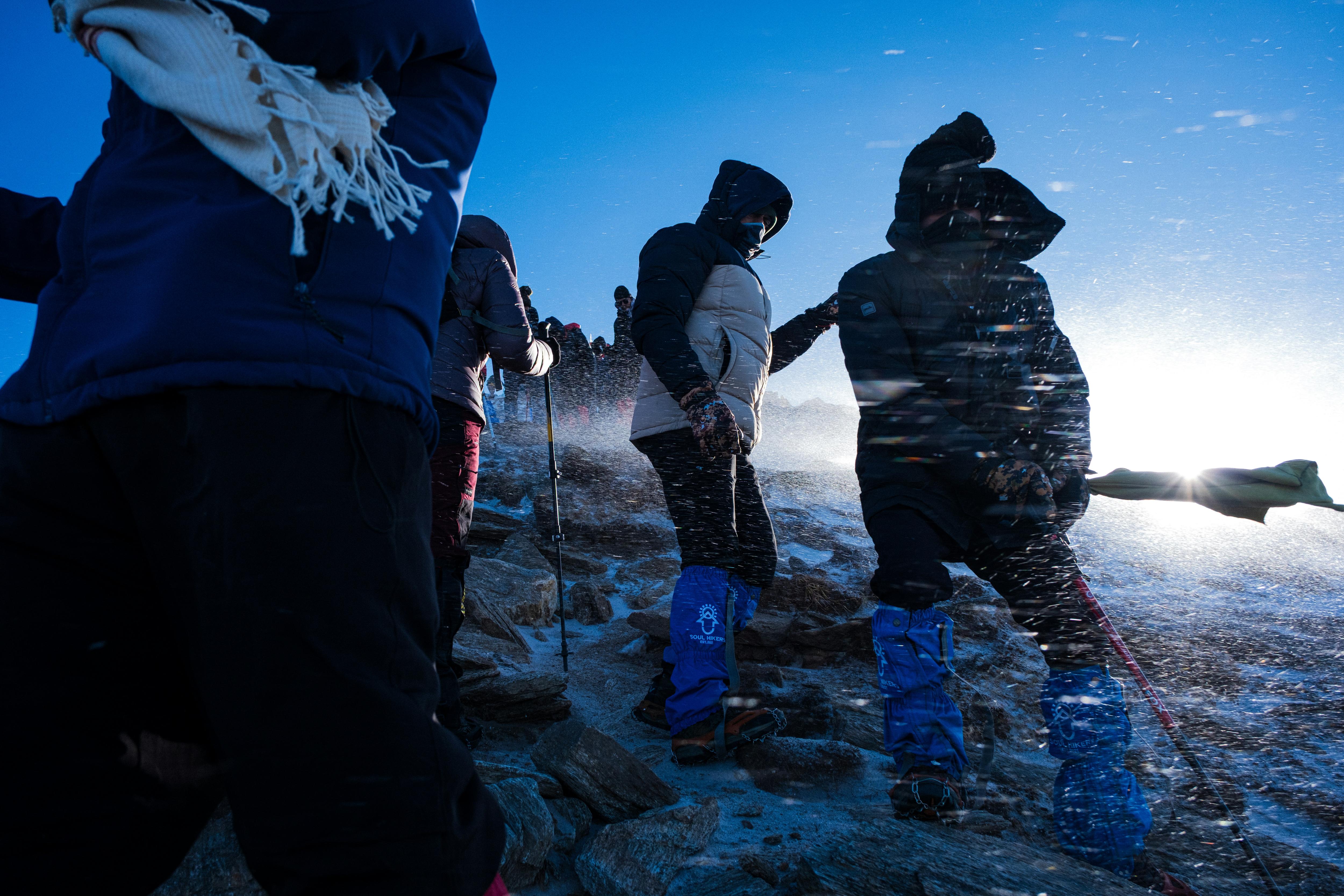 Hikers in windy alpine area.