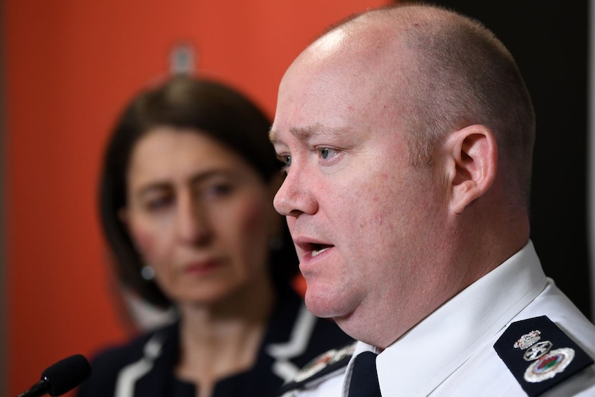 Shane Fitzsimmons speaks to the media while NSW Premier Gladys Berejiklian looks on.