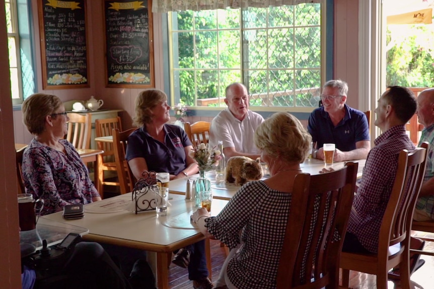 A group of pub owners sit around a table and discuss how they bought the venue.